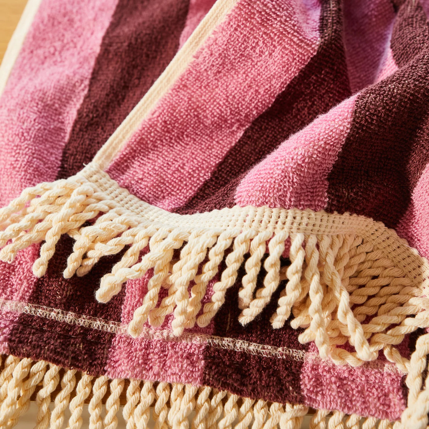 fringe details of the sage and clare jarita hooded towel in roseway