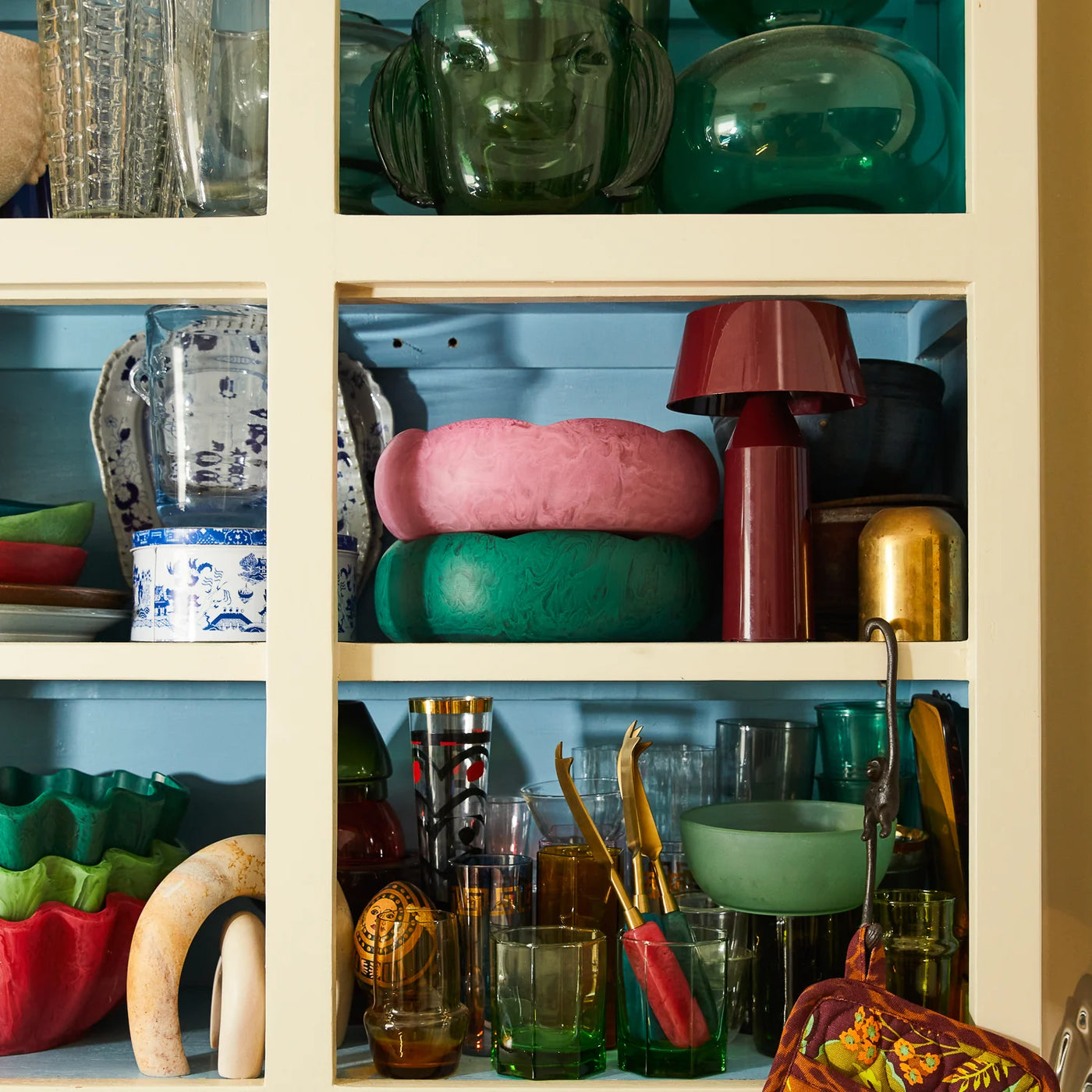 cabinet with bowls, glasses and glass with penny cheese knife in different colours